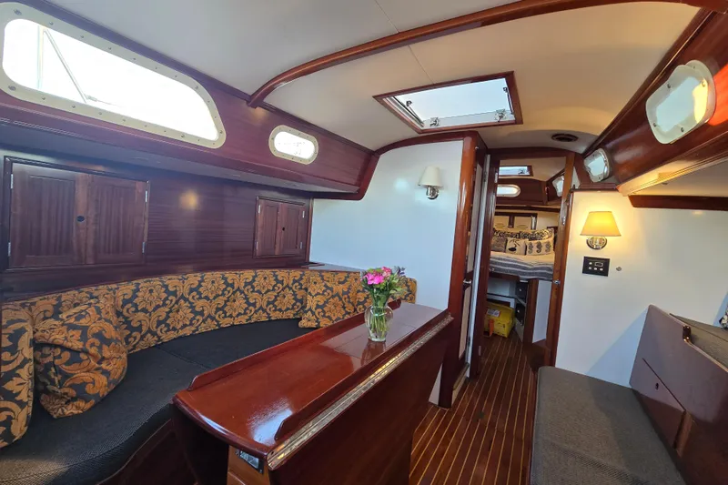Slide: The Image of Interior of a 1970 Hinckley Bermuda 40 sailboat with elegant wood finish and cozy seating. - 107