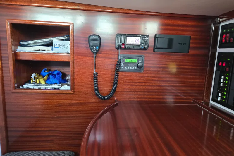 Slide: The Image of Interior of 1970 Hinckley Bermuda 40 yacht with radio equipment and wooden shelving. - 110