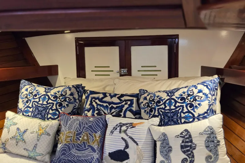 Slide: The Image of Cozy cabin interior of 1970 Hinckley Bermuda 40 with nautical-themed pillows. - 112