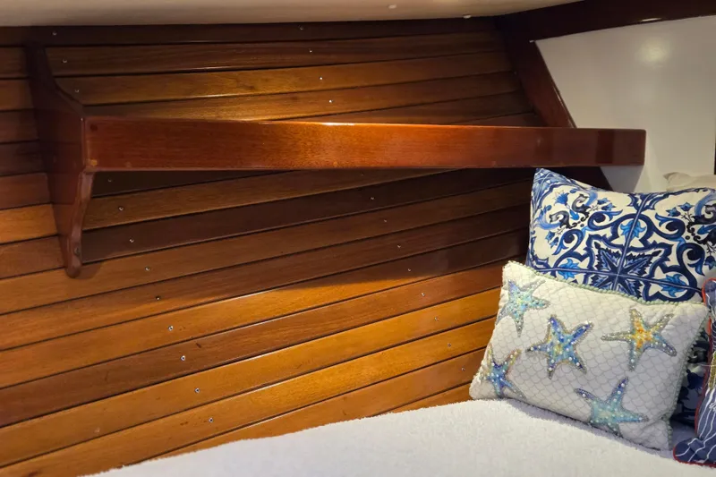 Slide: The Image of Cozy interior of 1970 Hinckley Bermuda 40 with wooden paneling and decorative pillows. - 113