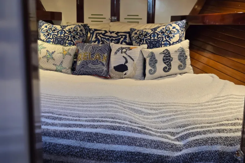 Slide: The Image of Cozy cabin interior of 1970 Hinckley Bermuda 40 with nautical-themed pillows. - 115