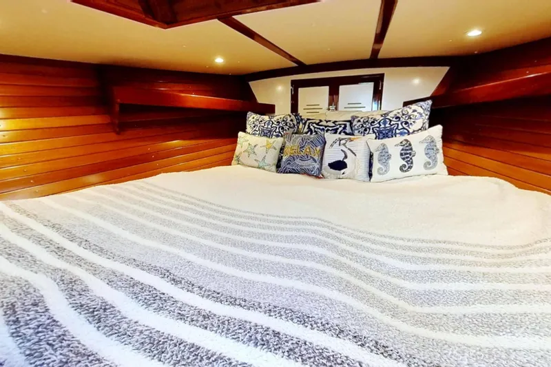Slide: The Image of Cozy cabin interior of 1970 Hinckley Bermuda 40 with nautical-themed pillows. - 116