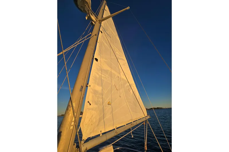 Slide: The Image of Sail of a 1970 Hinckley Bermuda 40 yacht against a clear blue sky. - 117