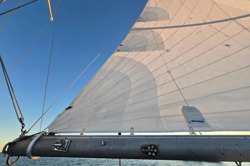 Slide: The Image of Sail of a 1970 Hinckley Bermuda 40 yacht against a clear blue sky. - 120
