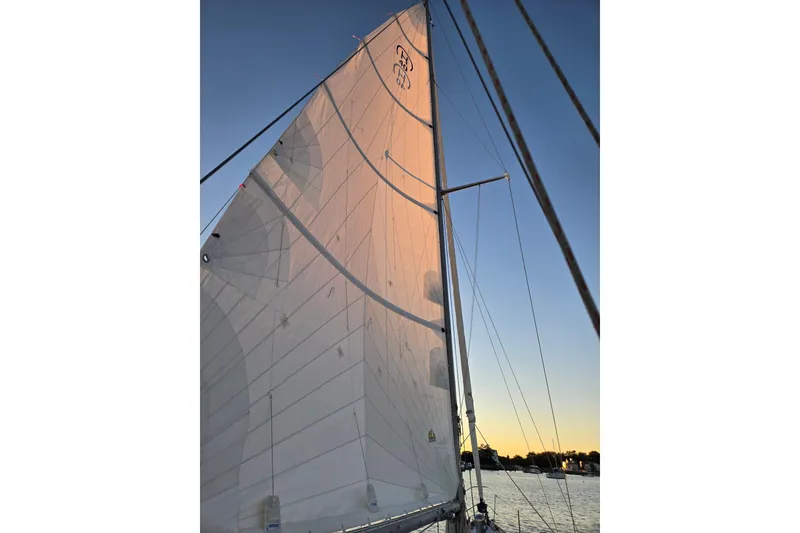 Slide: The Image of Sailing at sunset on a 1970 Hinckley Bermuda 40, showcasing its majestic sails. - 123