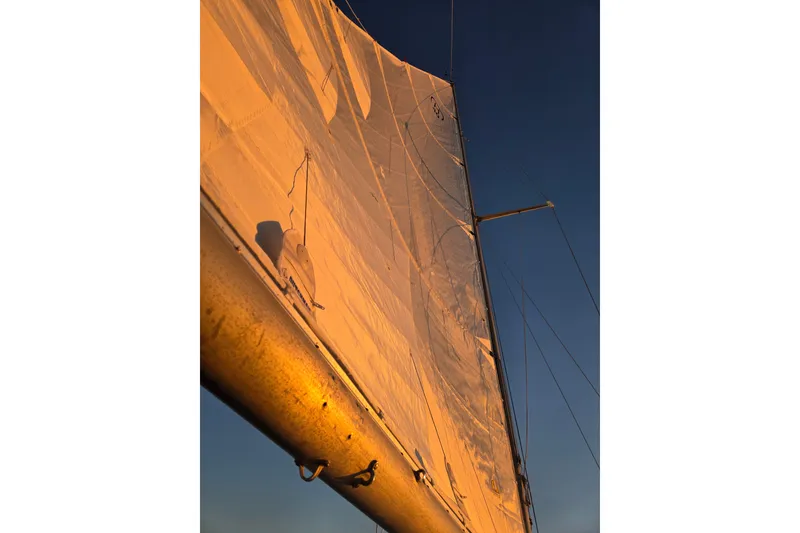 Slide: The Image of Sail of a 1970 Hinckley Bermuda 40 yacht illuminated by sunset light. - 125