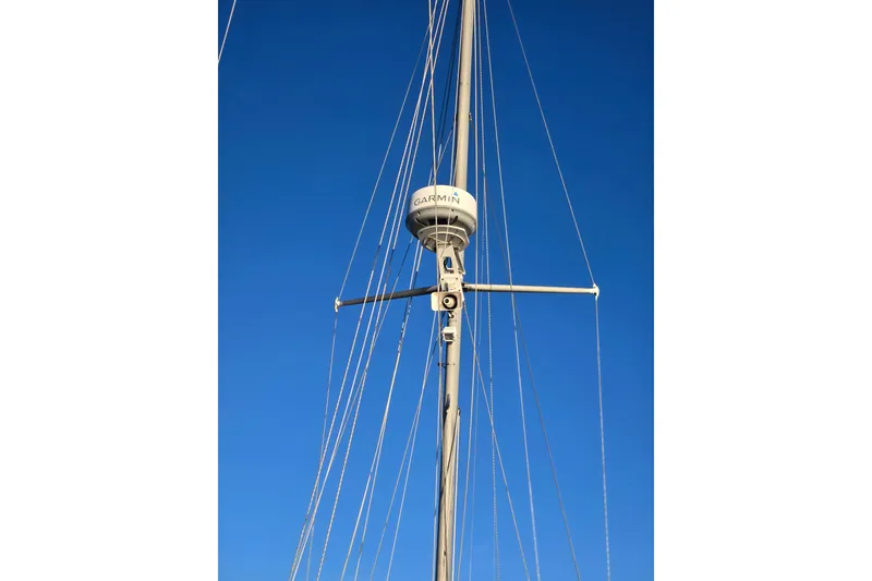 Slide: The Image of Mast of 1970 Hinckley Bermuda 40 sailboat with Garmin radar against clear blue sky. - 129