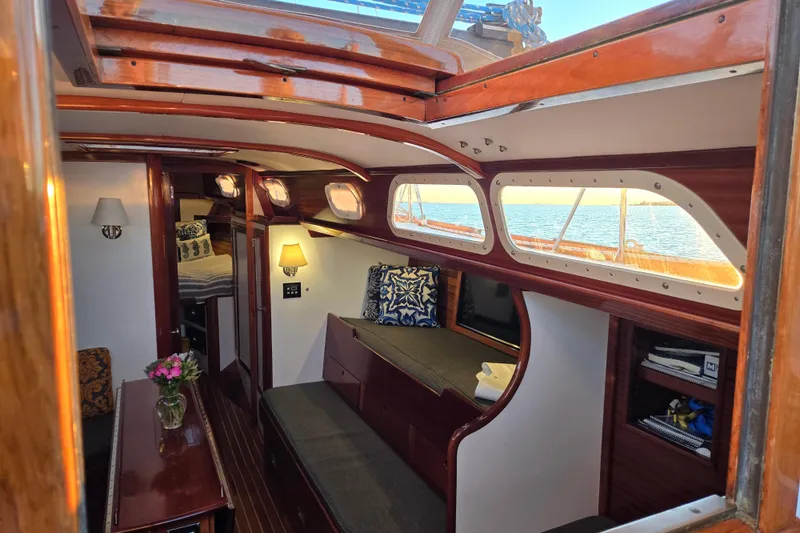 Slide: The Image of Interior of a 1970 Hinckley Bermuda 40 sailboat with elegant wood finish and cozy seating. - 131