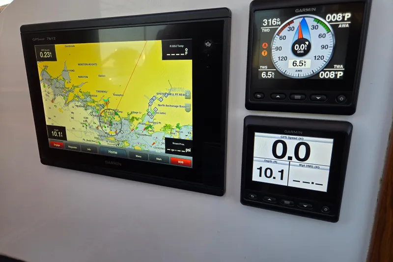 Slide: The Image of Garmin navigation displays on a 1970 Hinckley Bermuda 40 sailboat, showing maps and sailing data. - 136