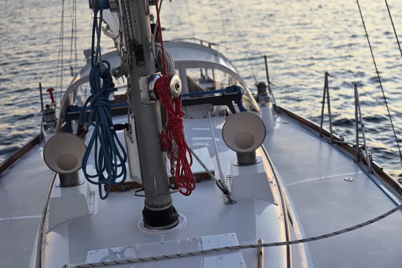 Slide: The Image of 1970 Hinckley Bermuda 40 sailboat deck with ropes and ocean backdrop. - 143