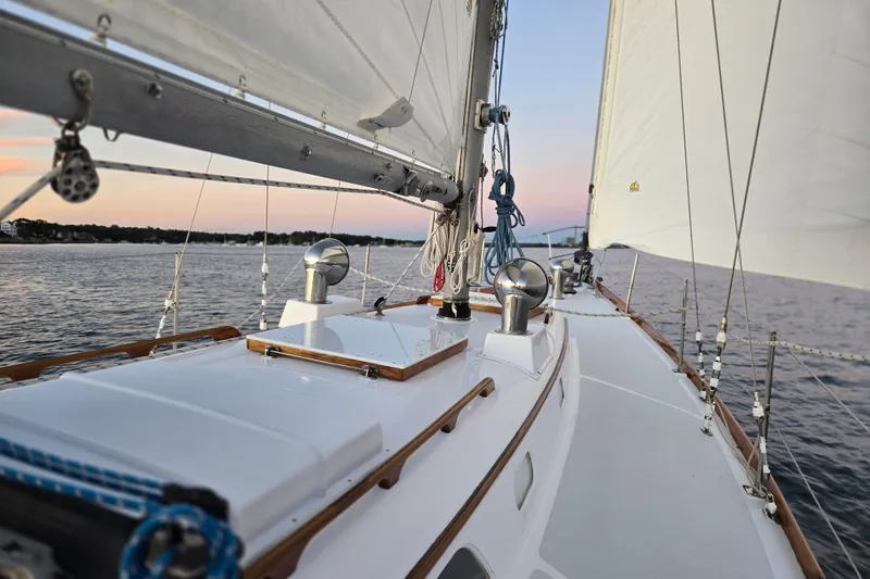 Slide: The Image of Sailing on a 1970 Hinckley Bermuda 40 yacht at sunset, showcasing elegant deck design. - 144