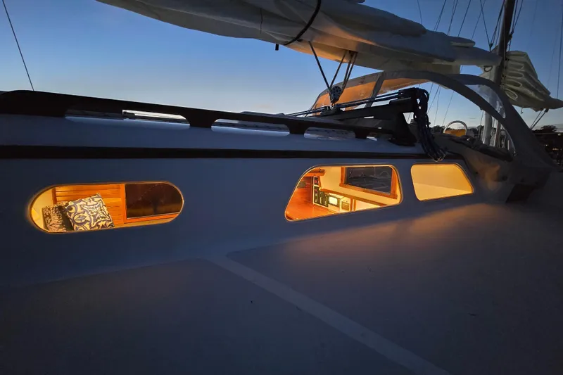 Slide: The Image of 1970 Hinckley Bermuda 40 sailboat interior warmly lit at dusk. - 154