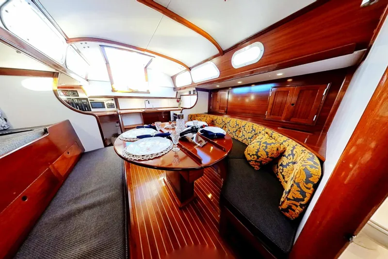 Slide: The Image of Interior of a 1970 Hinckley Bermuda 40 yacht with elegant wood finish and cozy seating. - 155