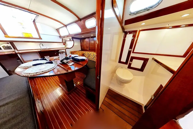 Slide: The Image of Interior of 1970 Hinckley Bermuda 40 yacht with dining area and bathroom. - 157