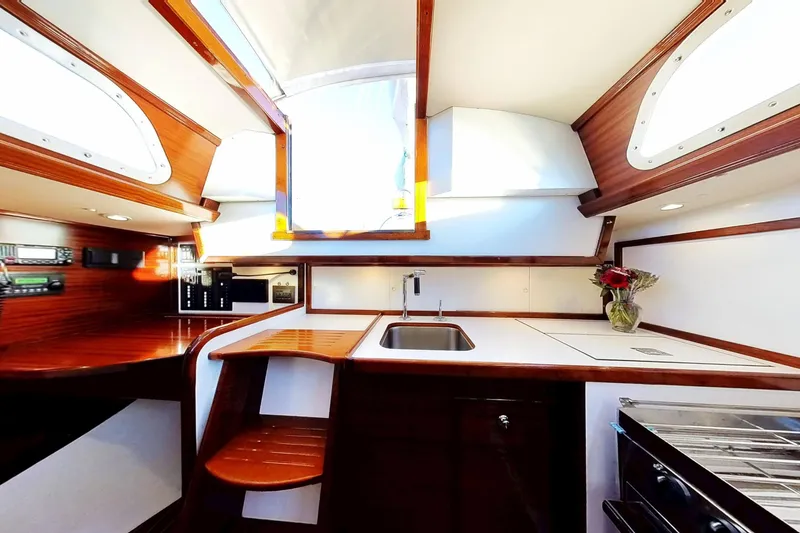 Slide: The Image of Interior of a 1970 Hinckley Bermuda 40 sailboat, featuring a modern kitchen area. - 158