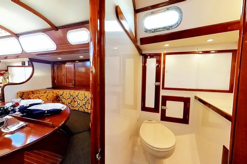 Slide: The Image of Interior of a 1970 Hinckley Bermuda 40 yacht, featuring elegant woodwork and cozy seating. - 159
