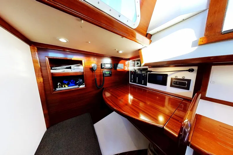Slide: The Image of Interior of a 1970 Hinckley Bermuda 40 sailboat with polished wood and navigation equipment. - 161
