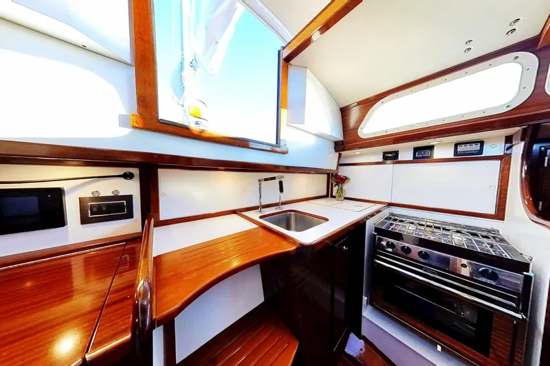 Slide: The Image of Interior of 1970 Hinckley Bermuda 40 yacht kitchen with wood finish and modern appliances. - 162