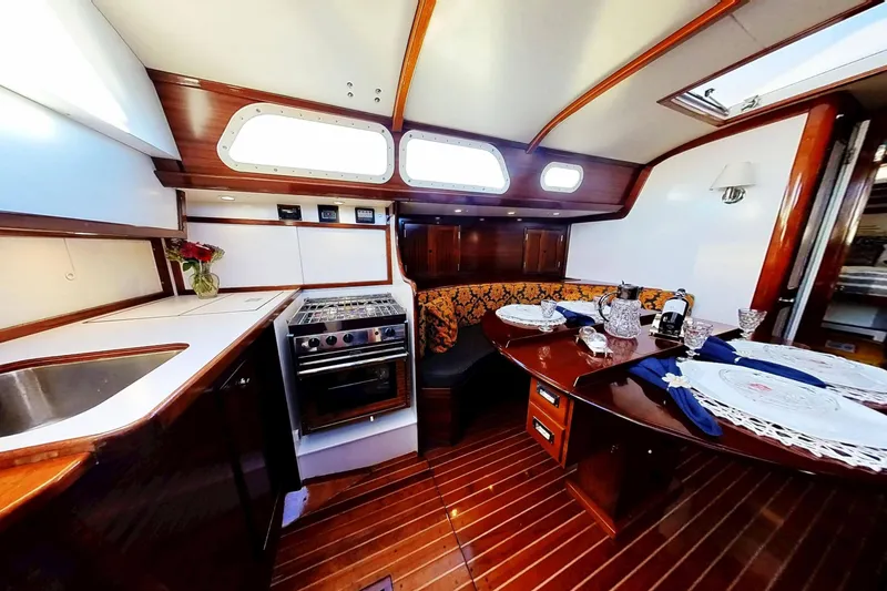 Slide: The Image of Interior of 1970 Hinckley Bermuda 40 yacht with elegant dining area and kitchen. - 163