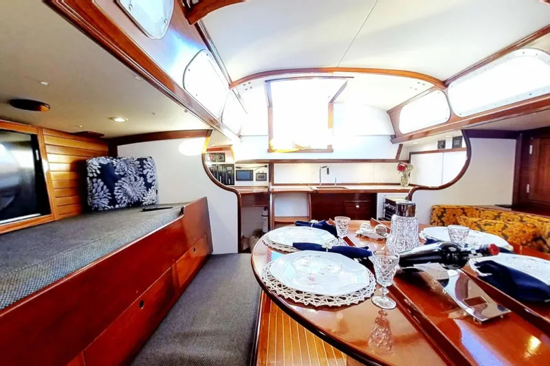 Slide: The Image of Interior of a 1970 Hinckley Bermuda 40 yacht with elegant dining setup. - 165