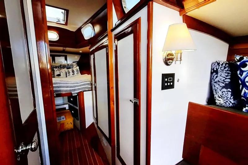 Slide: The Image of Interior of a 1970 Hinckley Bermuda 40 sailboat, featuring cozy wooden cabin and nautical decor. - 167