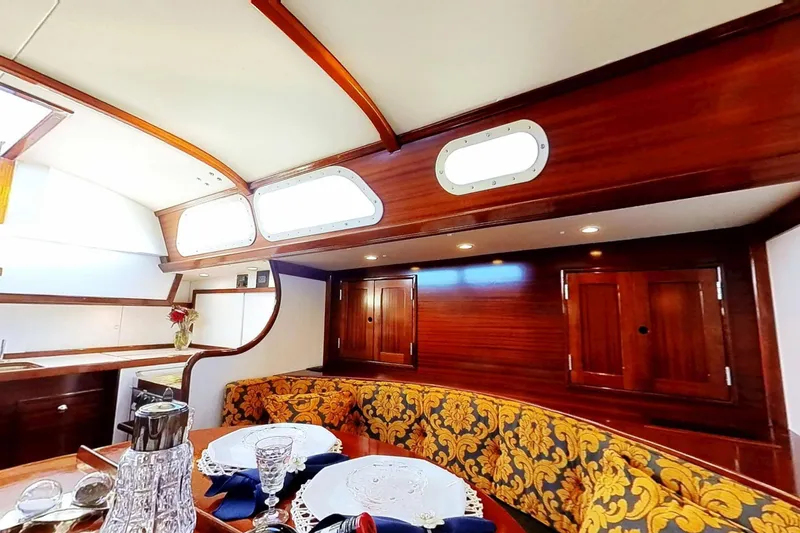 Slide: The Image of Interior of a 1970 Hinckley Bermuda 40 yacht with elegant wood finish and dining area. - 168
