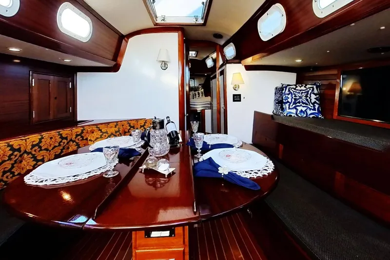 Slide: The Image of Luxurious interior of a 1970 Hinckley Bermuda 40 yacht with elegant dining setup. - 170