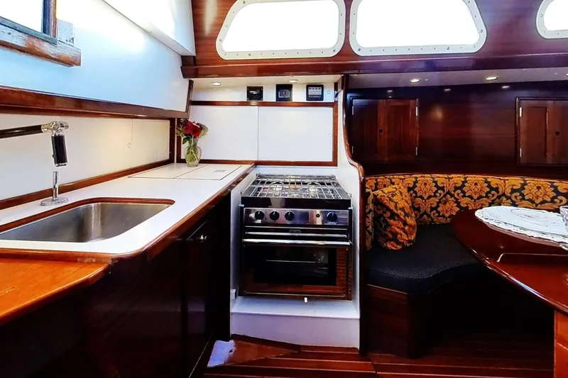 Slide: The Image of Interior of a 1970 Hinckley Bermuda 40 yacht with kitchen and seating area. - 172