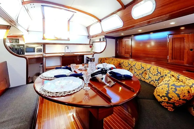 Slide: The Image of Luxurious interior of a 1970 Hinckley Bermuda 40 yacht with elegant dining setup. - 173