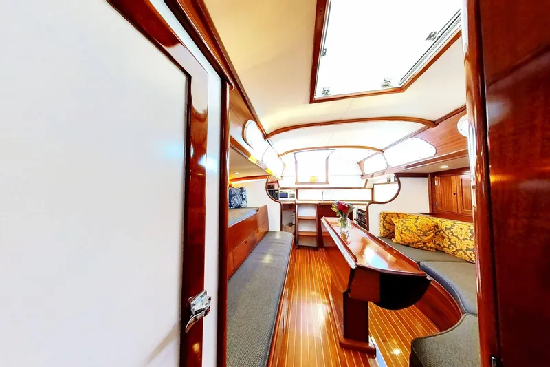 Slide: The Image of Interior of a 1970 Hinckley Bermuda 40 sailboat with polished wood and cozy seating. - 174