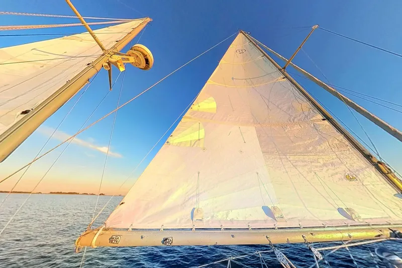 Slide: The Image of Sailing on a 1970 Hinckley Bermuda 40, vibrant sails against a clear blue sky. - 176