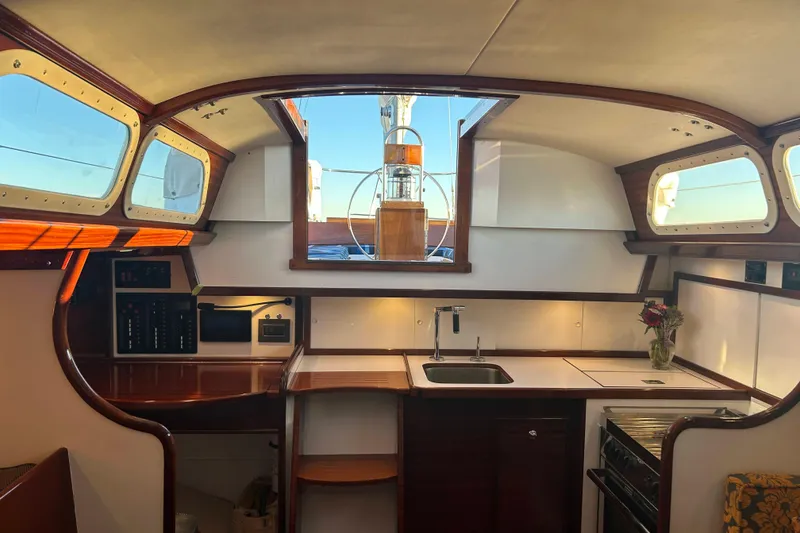 Slide: The Image of Interior of a 1970 Hinckley Bermuda 40 sailboat with wooden accents and modern amenities. - 24