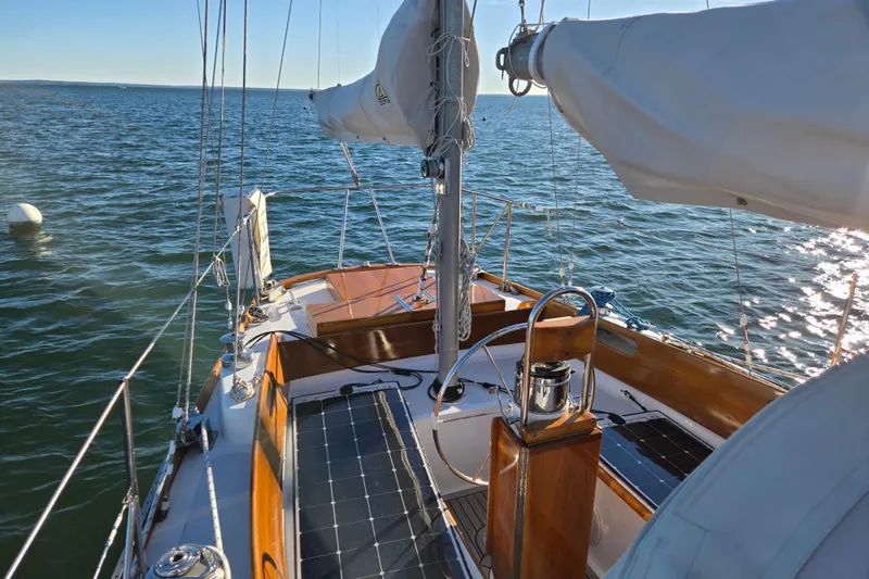 Slide: The Image of 1970 Hinckley Bermuda 40 sailboat on calm ocean waters, sunny day. - 25