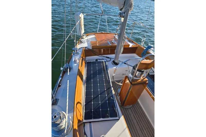 Slide: The Image of 1970 Hinckley Bermuda 40 sailboat deck with solar panel and wooden accents. - 26