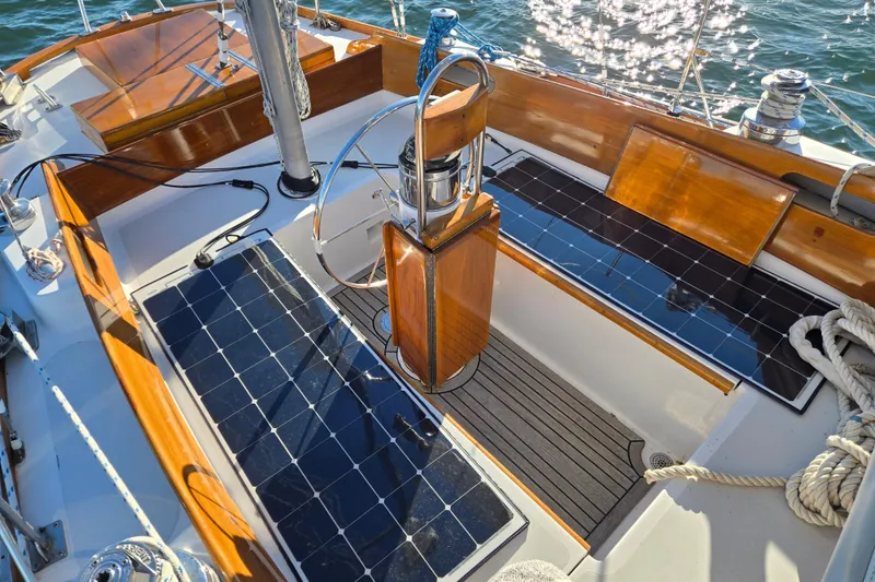 Slide: The Image of Cockpit of 1970 Hinckley Bermuda 40 sailboat with solar panels and wooden accents. - 27