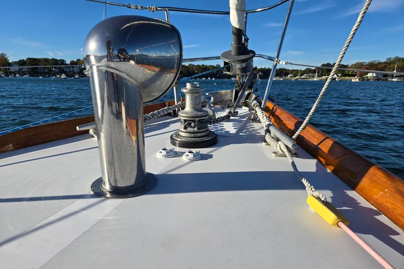 Slide: The Image of Hinckley Bermuda 40 sailboat deck with winch and ropes, sailing on a sunny day. - 28