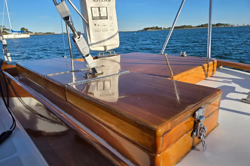 Slide: The Image of Hinckley Bermuda 40 sailboat, 1970 model, featuring polished wooden deck details on a sunny day. - 33