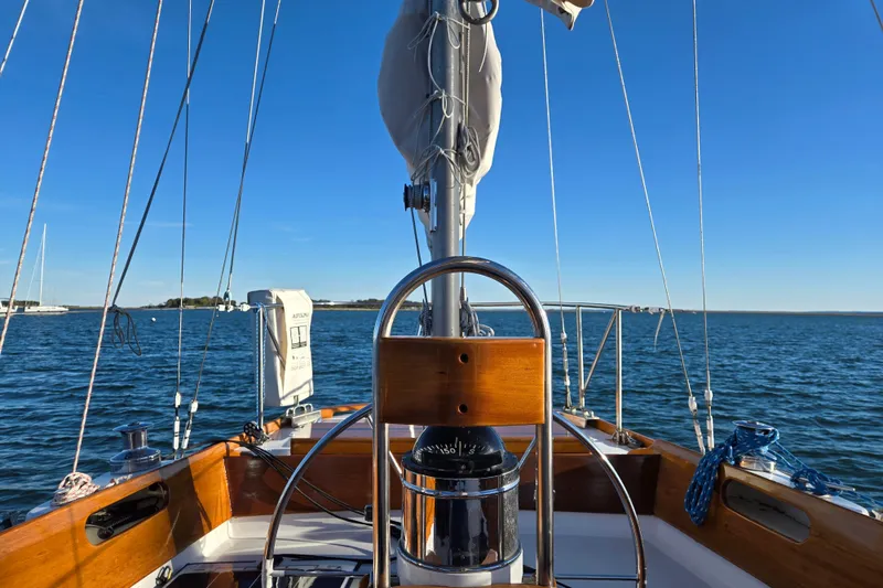 Slide: The Image of 1970 Hinckley Bermuda 40 sailboat cockpit with ocean view and clear blue sky. - 35