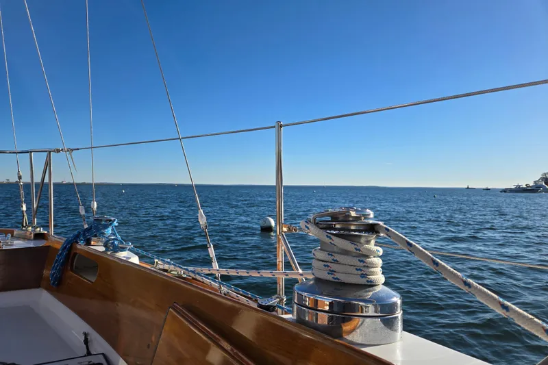 Slide: The Image of Hinckley Bermuda 40 sailboat deck view, 1970 model, overlooking calm blue ocean under clear sky. - 36