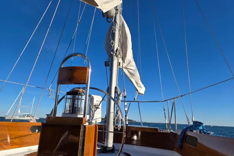 Slide: The Image of 1970 Hinckley Bermuda 40 sailboat deck with clear blue sky and ocean view. - 37