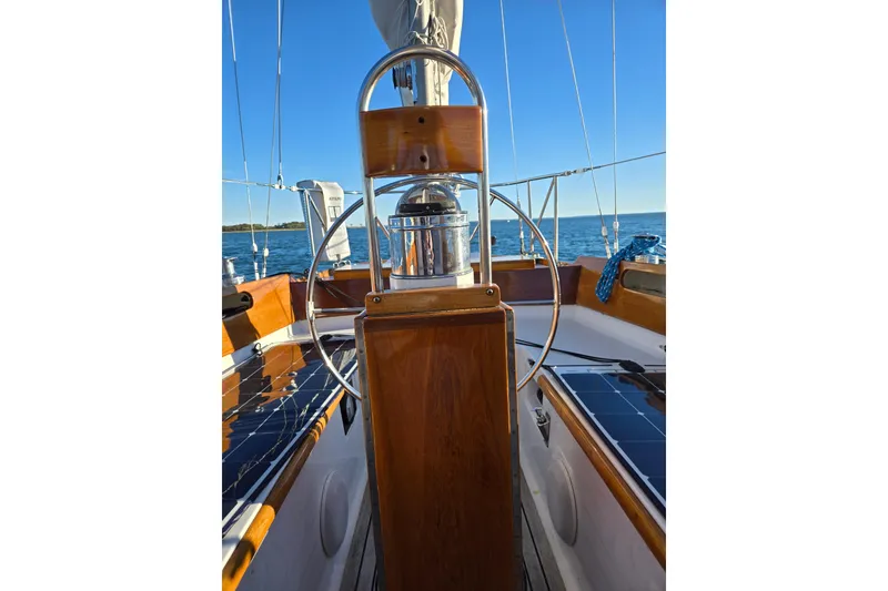 Slide: The Image of 1970 Hinckley Bermuda 40 sailboat cockpit with wooden helm and ocean view. - 38
