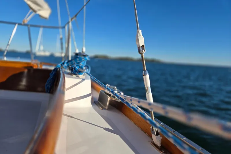 Slide: The Image of Close-up of 1970 Hinckley Bermuda 40 sailboat deck with blue ropes and ocean view. - 42
