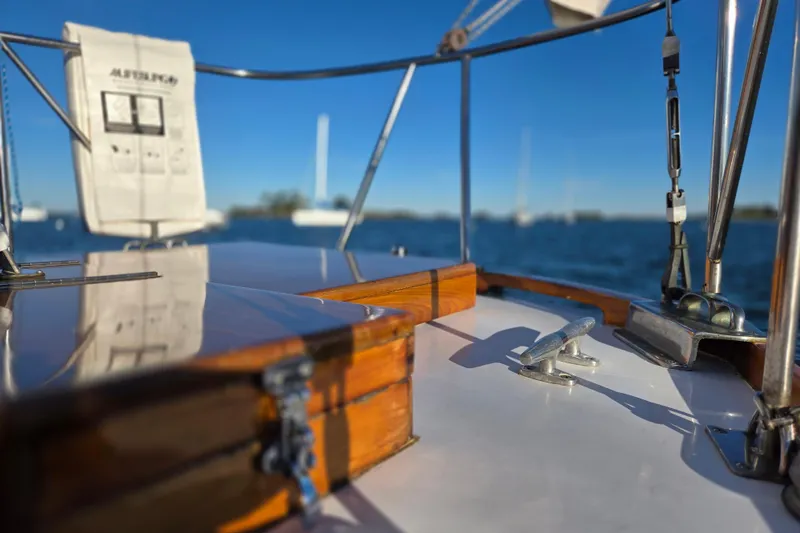 Slide: The Image of 1970 Hinckley Bermuda 40 sailboat deck with polished wood and ocean view. - 44