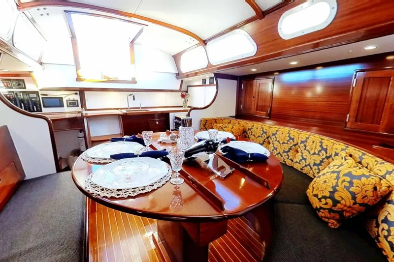 Slide: The Image of Luxurious 1970 Hinckley Bermuda 40 yacht interior with elegant dining area and plush seating. - 5