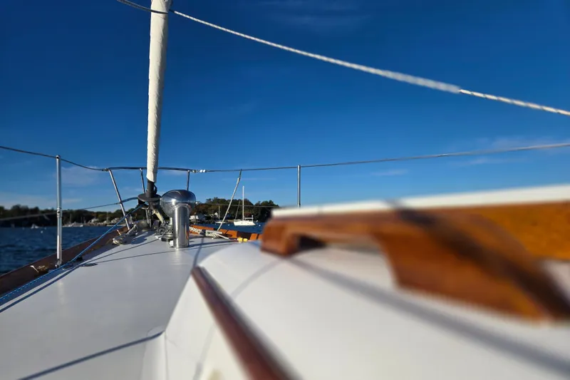 Slide: The Image of 1970 Hinckley Bermuda 40 sailboat deck with clear blue sky background. - 50