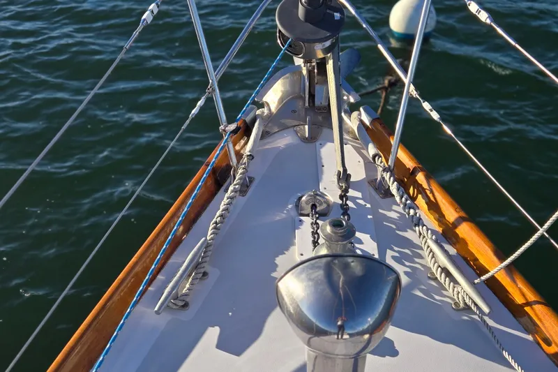 Slide: The Image of Bow of a 1970 Hinckley Bermuda 40 sailboat with ropes and winch on deck. - 52