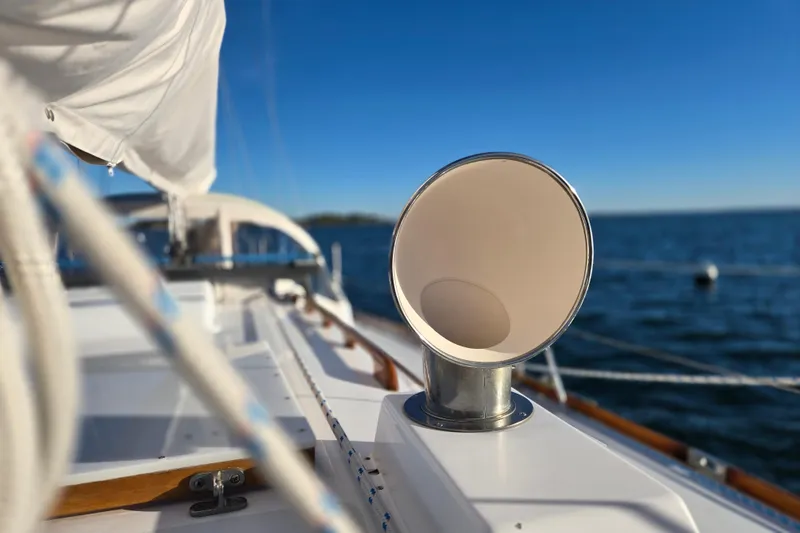 Slide: The Image of Hinckley Bermuda 40 sailboat deck with ocean view, featuring a chrome vent, 1970 model. - 56