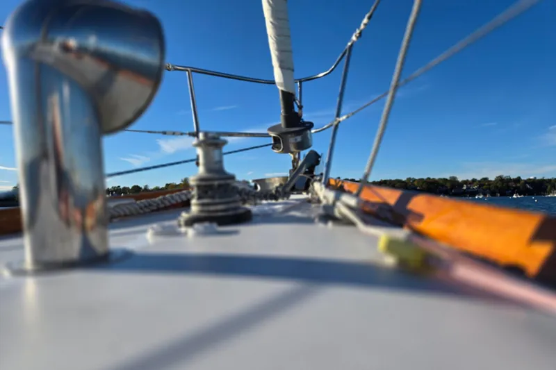 Slide: The Image of Deck view of a 1970 Hinckley Bermuda 40 sailboat under clear blue skies. - 58