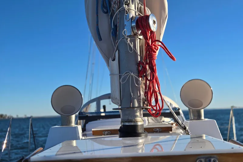 Slide: The Image of Hinckley Bermuda 40 sailboat deck with mast and rigging, 1970 model, on open water. - 60