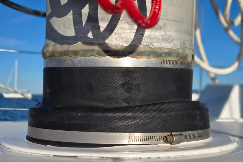 Slide: The Image of Close-up of a 1970 Hinckley Bermuda 40 sailboat mast detail with clamps and ropes. - 61